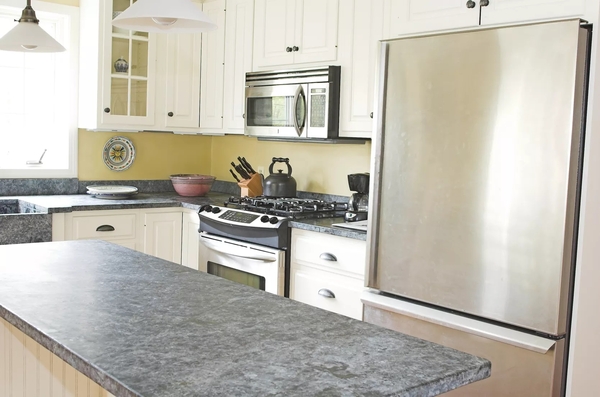 sunny-country-kitchen-with-stone-counter-and-stainless-steel-172658456-5b705ed44.jpg